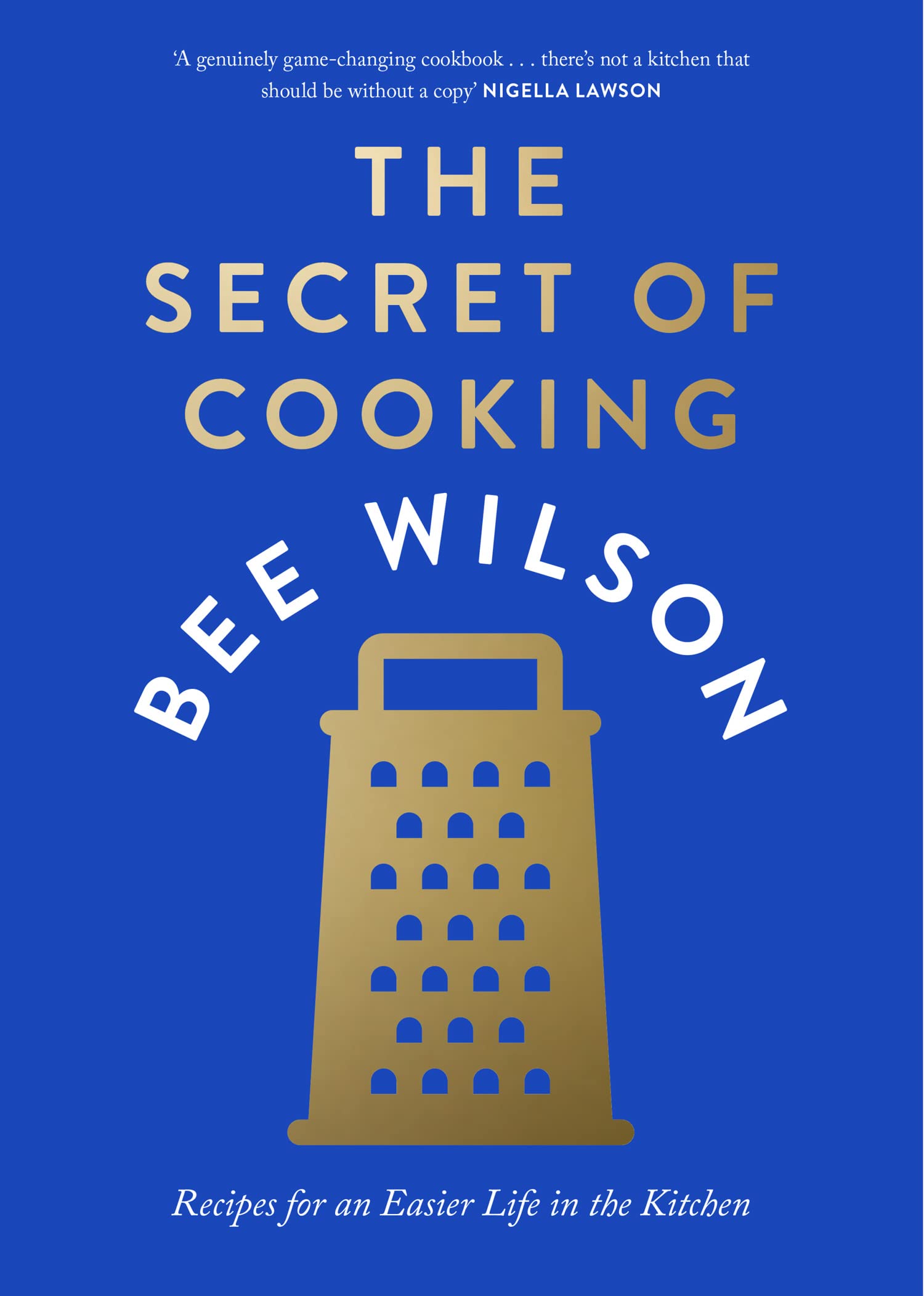 Hardback book "The Secret of Cooking" by Bee Wilson, showcasing an engaging cover design on a wooden table.