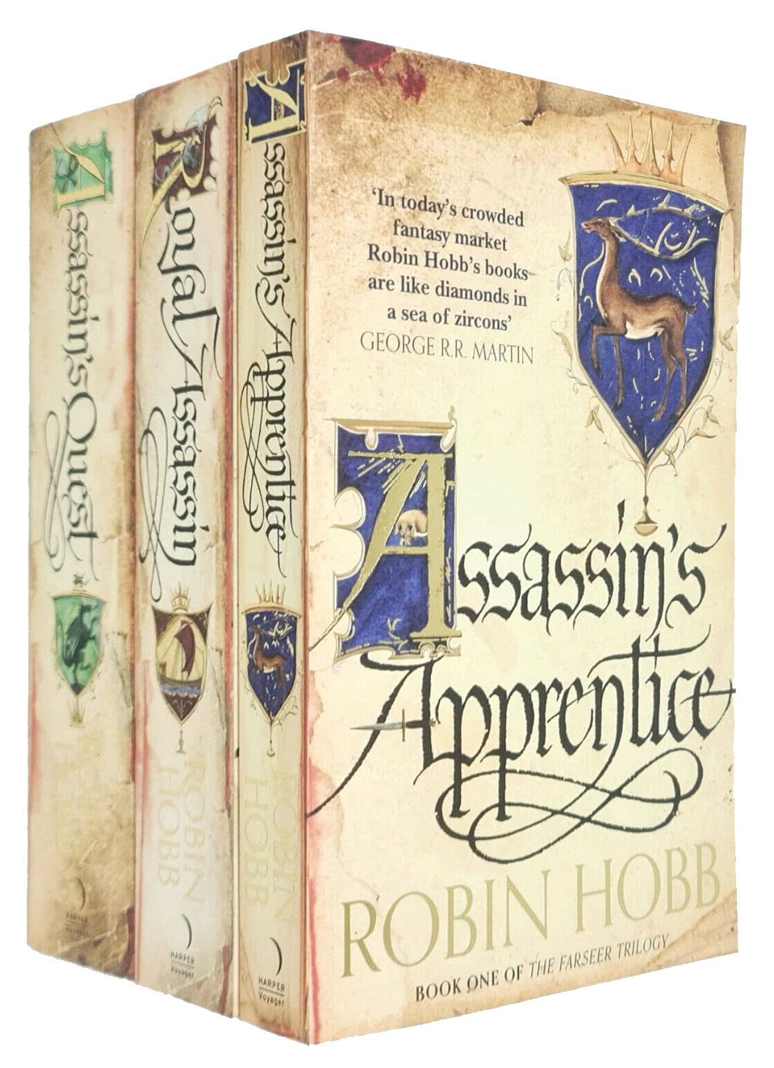 Three paperback books from Robin Hobb's Farseer Trilogy collection, featuring fantasy fiction with illustrated covers.