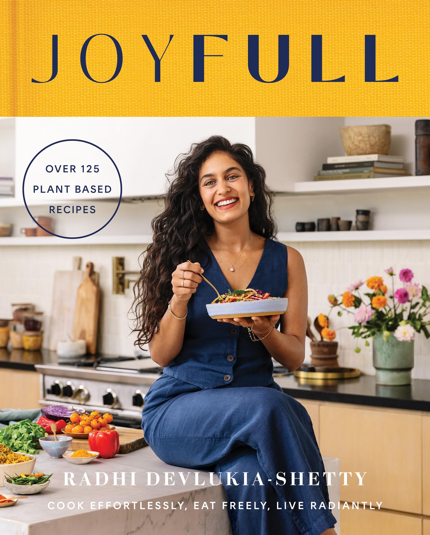 Paperback copy of "Joyfull" by Radhi Devlukia, featuring the cover design and author's name prominently displayed.