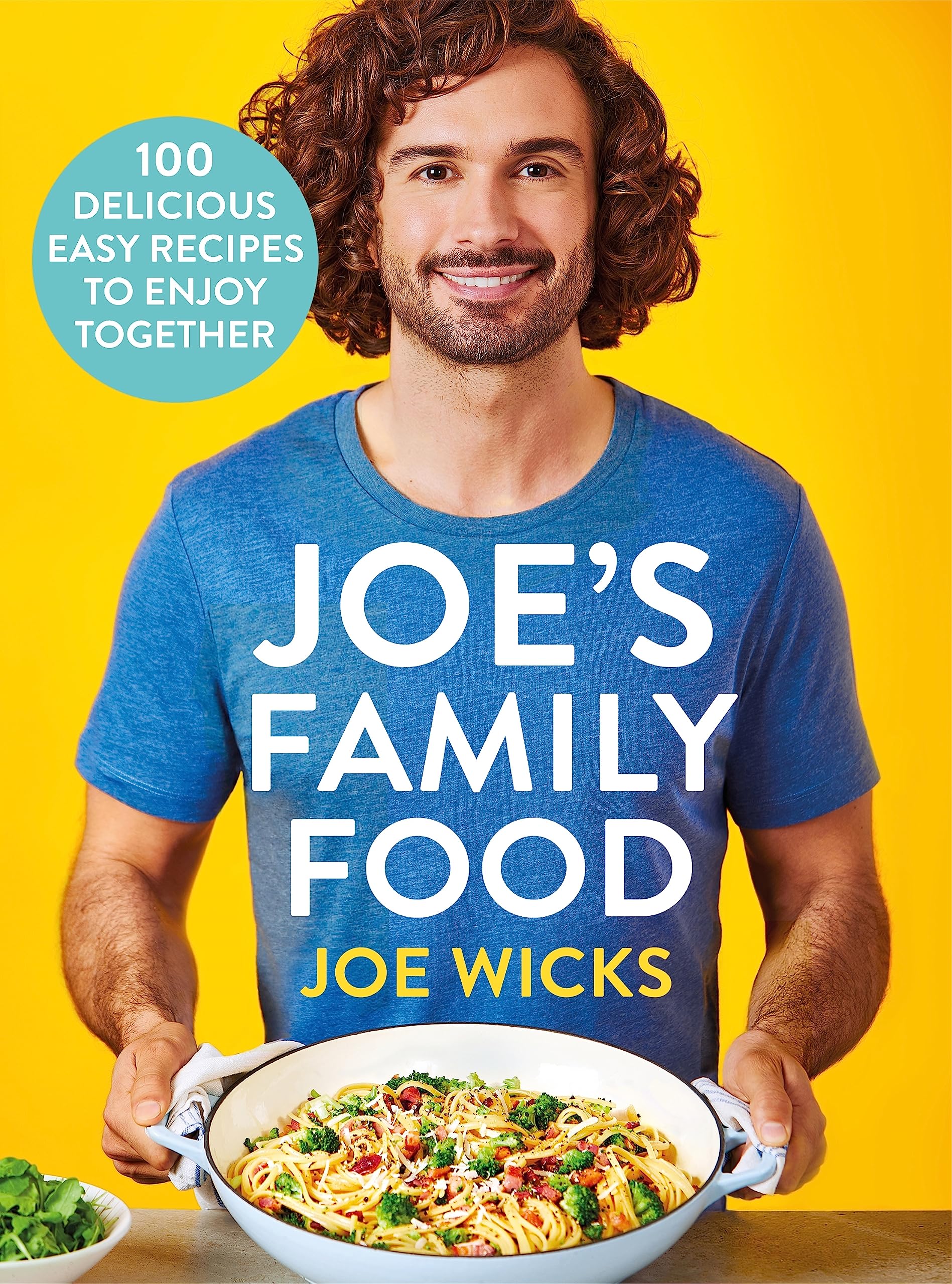 Hardback copy of "Joe's Family Food" by Joe Wicks, featuring colorful recipes and a family-friendly layout.