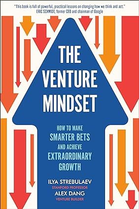 The Venture Mindset Collection by Various Authors, featuring two paperback books, displayed on a wooden surface.