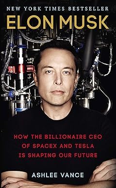 Two paperback books from the Elon Musk collection by Ashlee Vance, featuring various authors, stacked together.