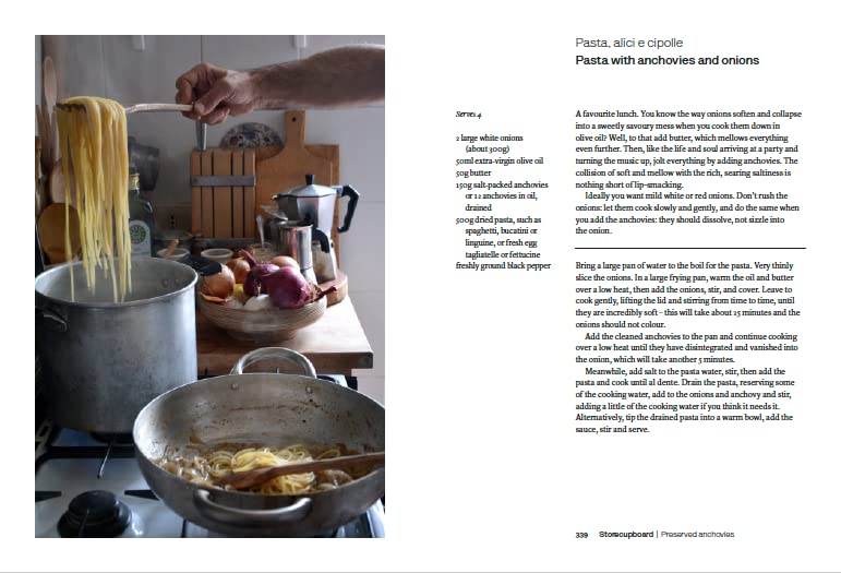 Hardback copy of "Two Kitchens" by Rachel Roddy showcasing the book cover with vibrant food imagery.