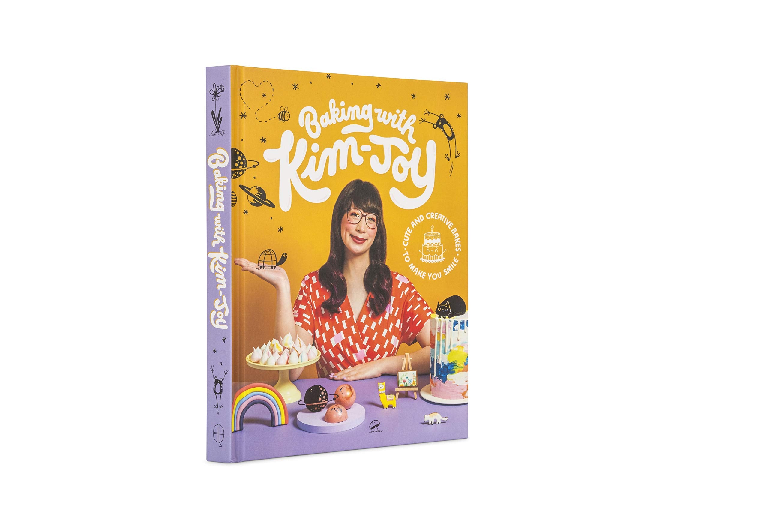 Hardback book "Baking With Kim-Joy" by Kim-Joy, featuring colorful recipes and charming illustrations on the cover.