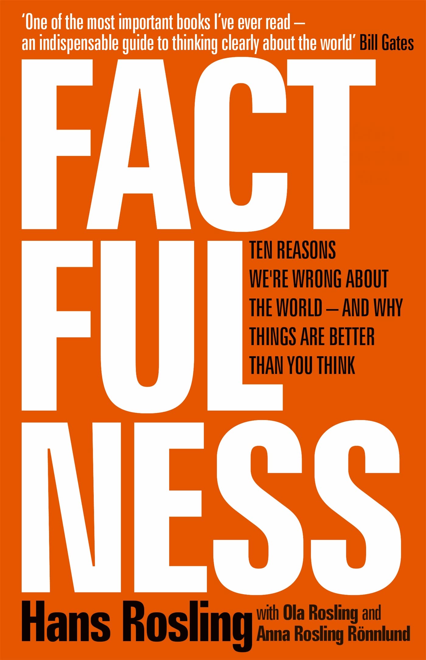 Hardback copy of "Factfulness" by Hans Rosling, featuring a blue cover with white and yellow text on a wooden surface.