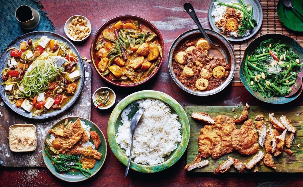 Hardback copy of "Simple Family Feasts" by Jeremy Pang, showcasing vibrant recipes and cooking tips.