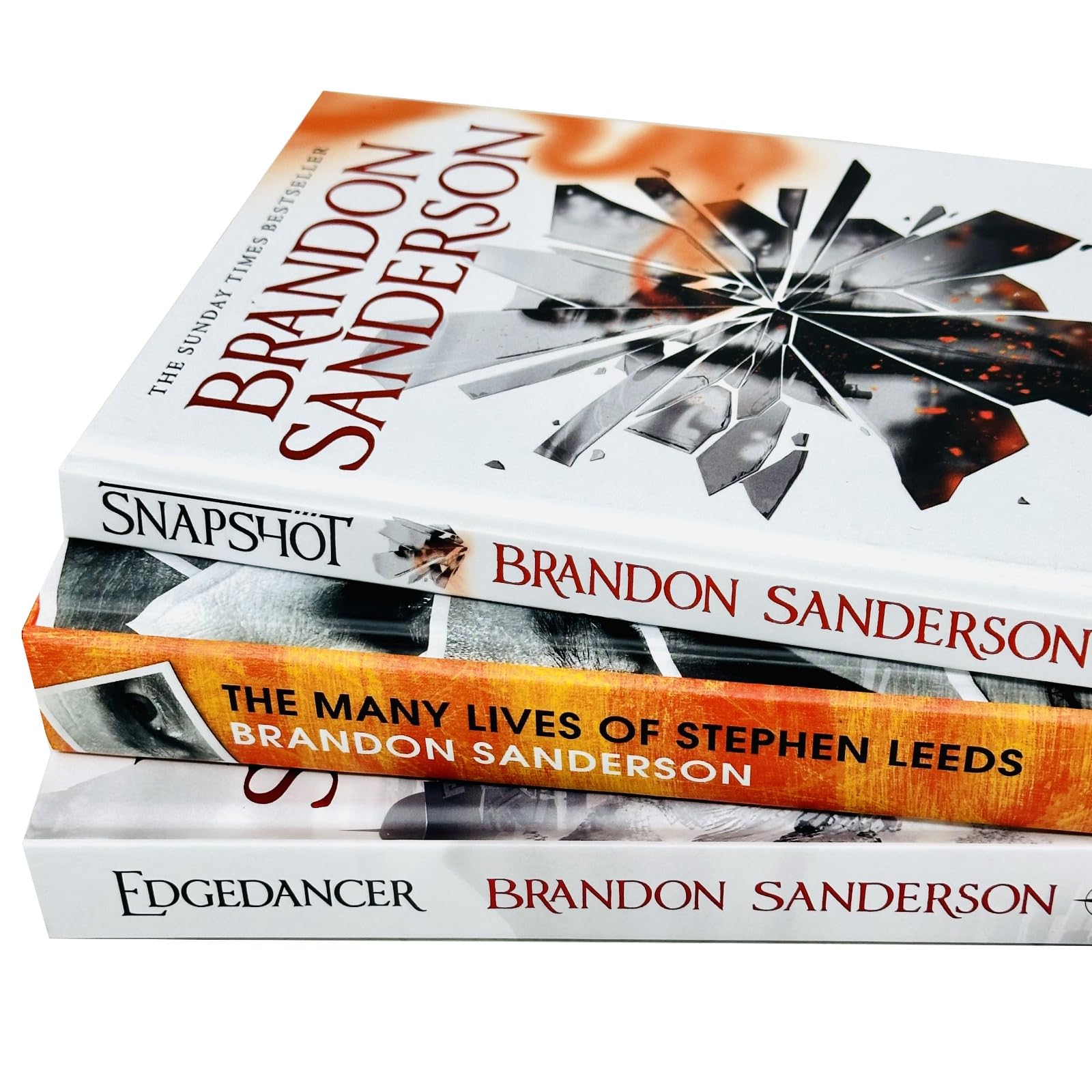 Brandon Sanderson's hardback fiction book collection featuring three novels, beautifully arranged on a shelf.