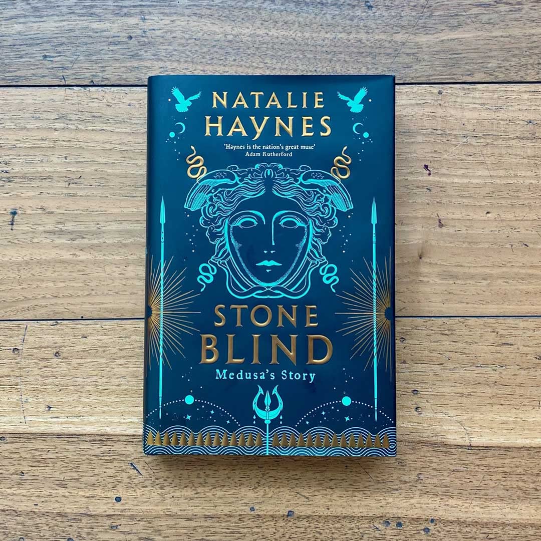 Hardback edition of "Stone Blind" by Natalie Haynes displayed on a mantle, showcasing its cover design and spine.