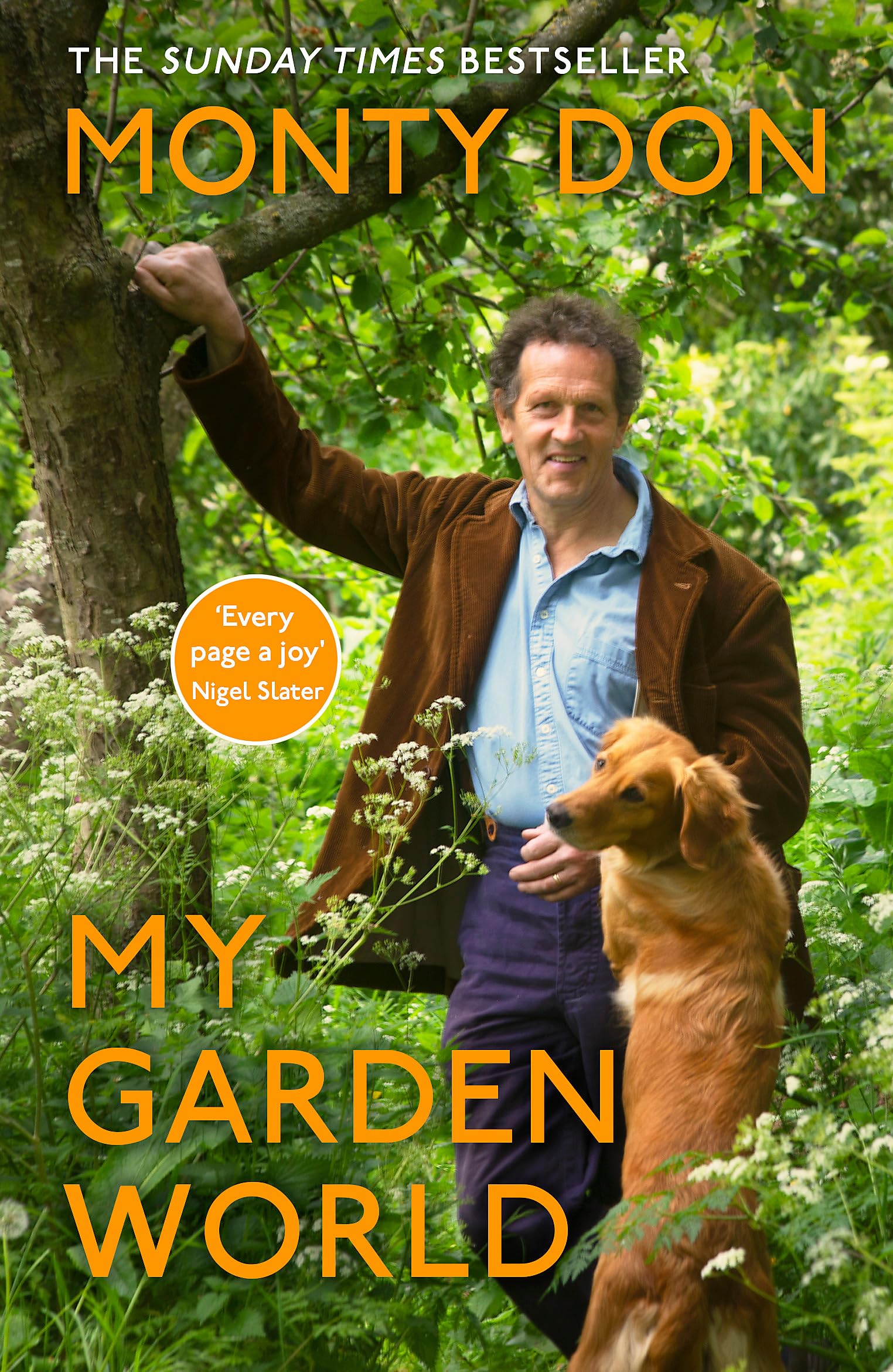 Paperback copy of "My Garden World" by Monty Don, featuring a vibrant garden scene on the cover.