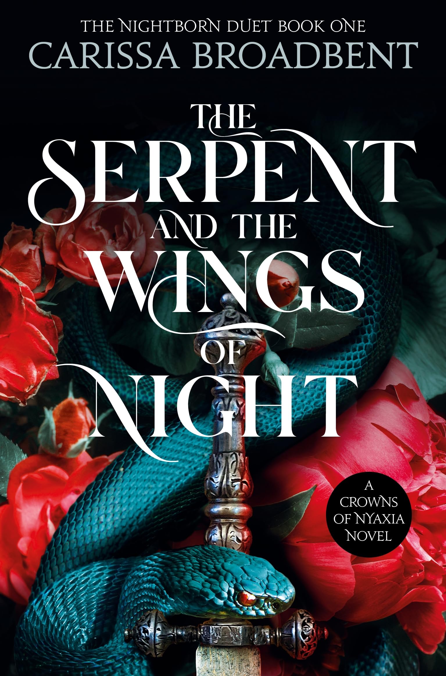 Paperback copy of "The Serpent and the Wings of Night" by Carissa Broadbent, featuring a fantasy-themed cover design.