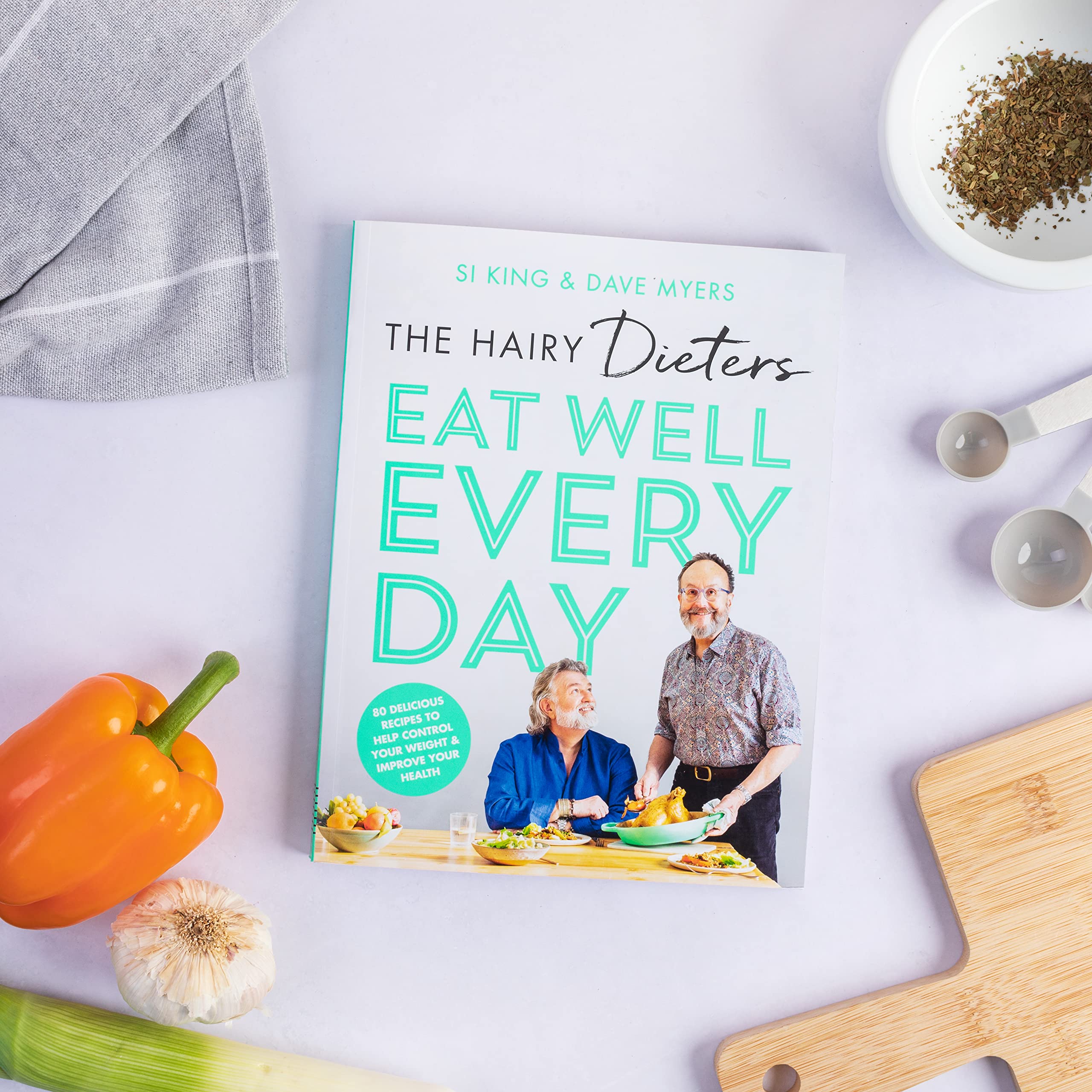 Paperback edition of "Hairy Dieters Eat Well Every Day" by The Hairy Bikers, featuring colorful recipes and meal ideas.