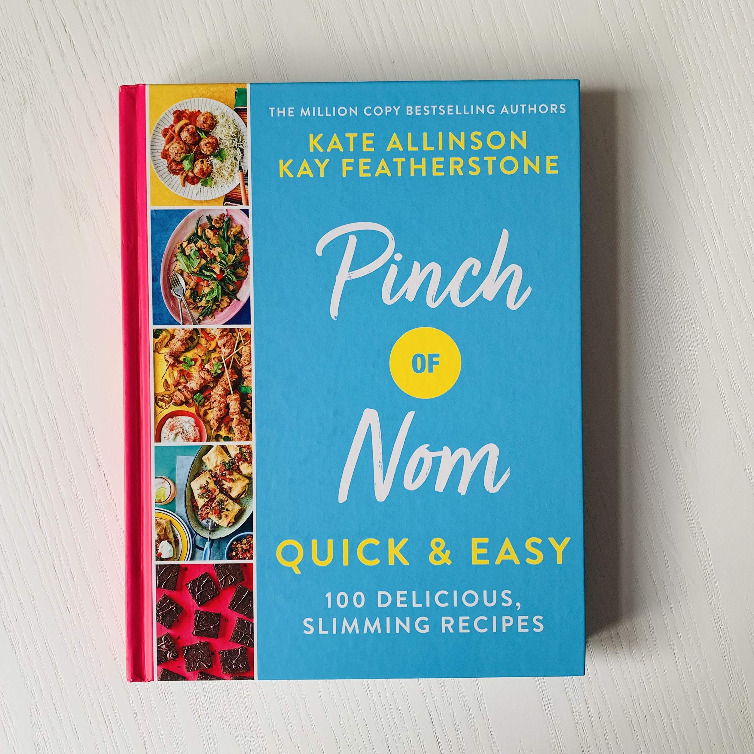 Hardback book "Pinch of Nom Quick and Easy" by Kay Featherstone, featuring a vibrant cover with recipes and cooking tips.
