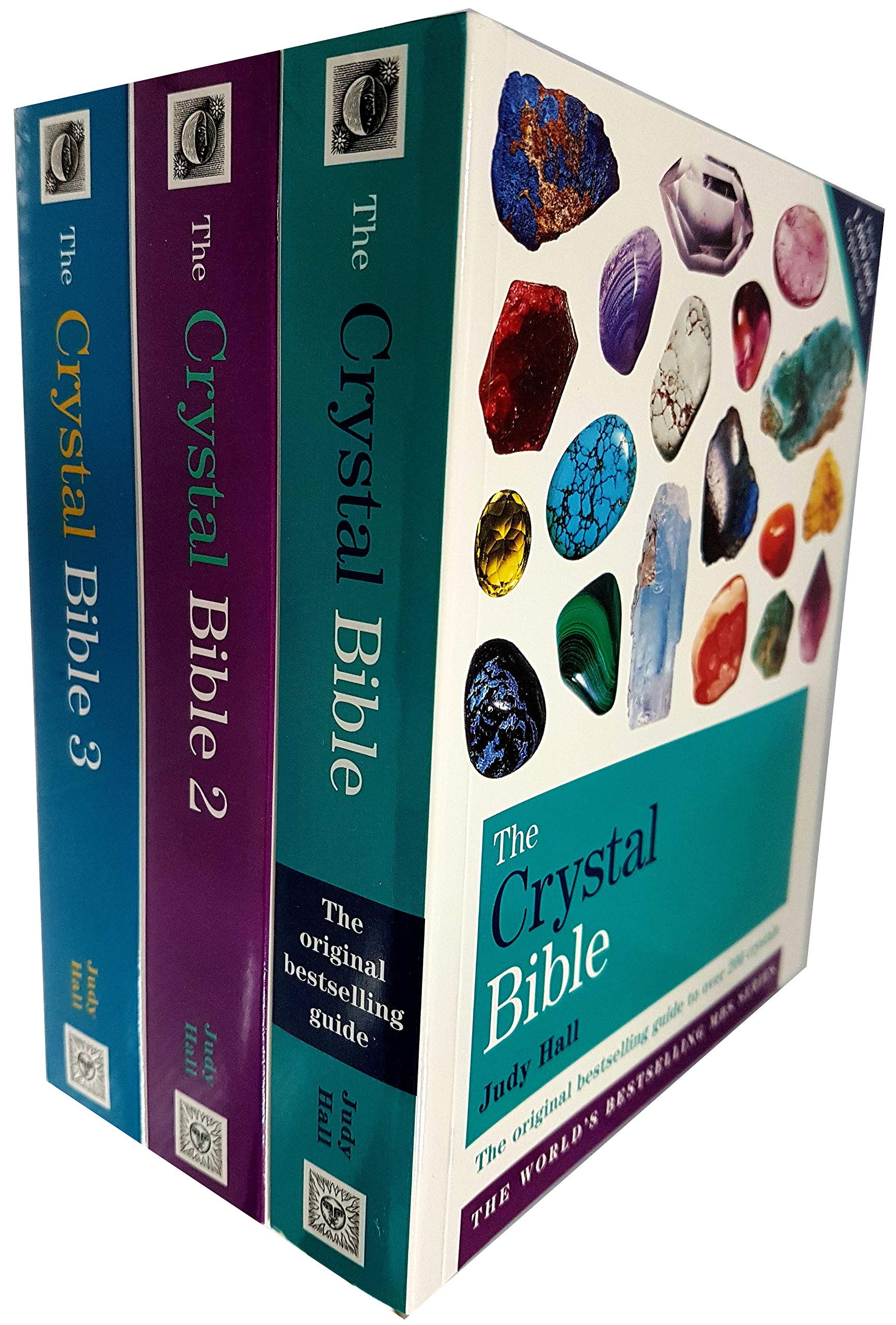 Three paperback books from The Crystal Bible collection by Judy Hall, featuring colorful covers and informative content.