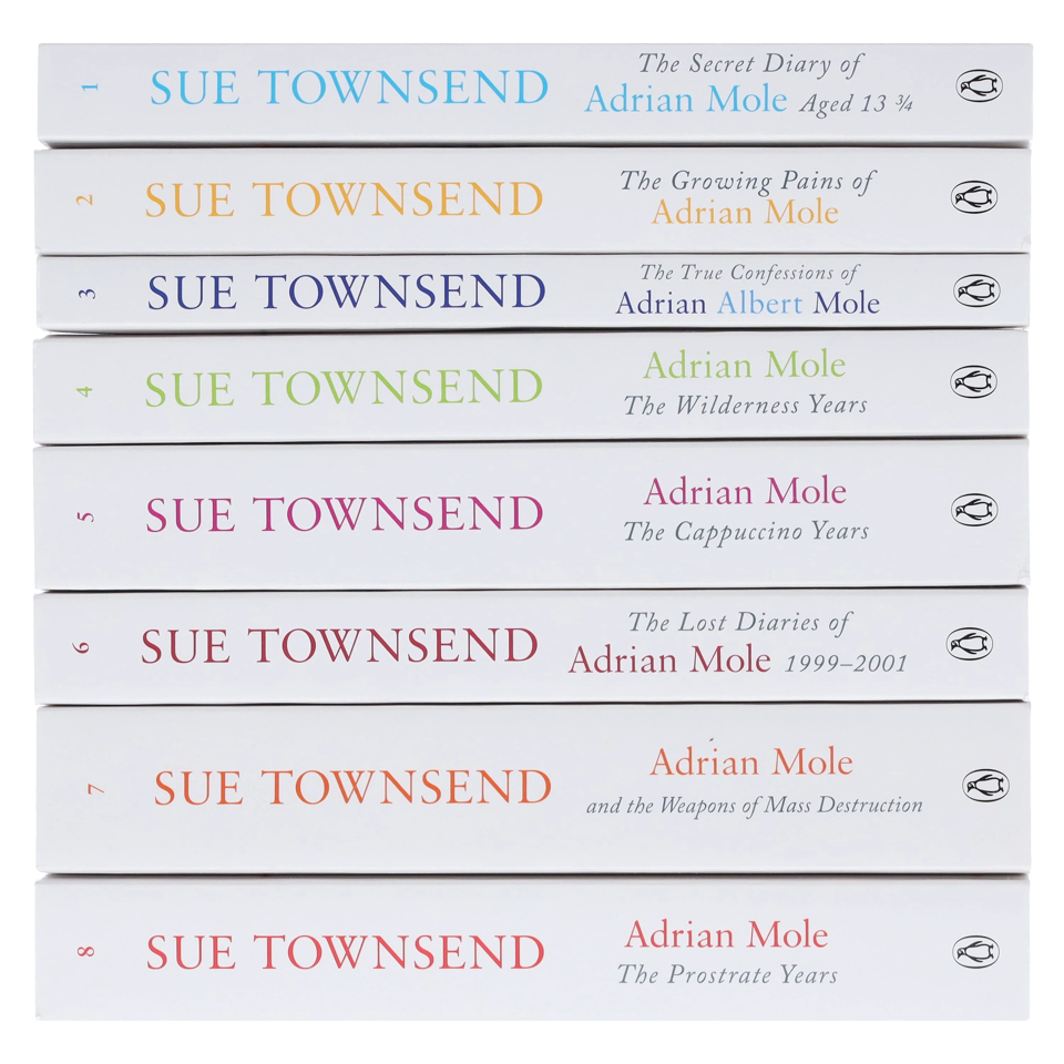 Stacked spines of the Adrian Mole 8-book paperback collection showing series titles
