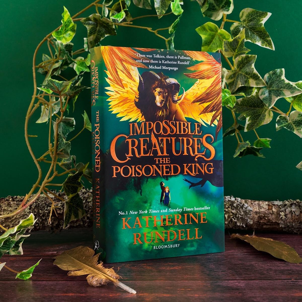 Impossible Creatures and The Poisoned King hardcover set fanned out showing both book covers side by side