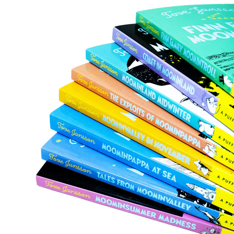 Close-up of Moomin paperback book spines stacked together showing titles