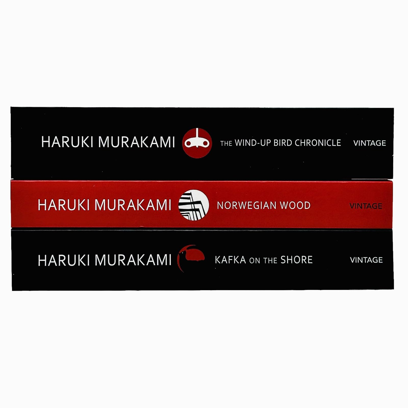 The three Haruki Murakami paperback novels stacked together on a wooden surface, showing the full 3 book collection set.