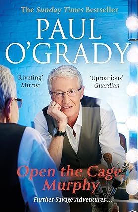 Both paperback books in the Paul O'Grady memoir collection displayed together, showing Still Standing and Open the Cage, Murphy! side by side.