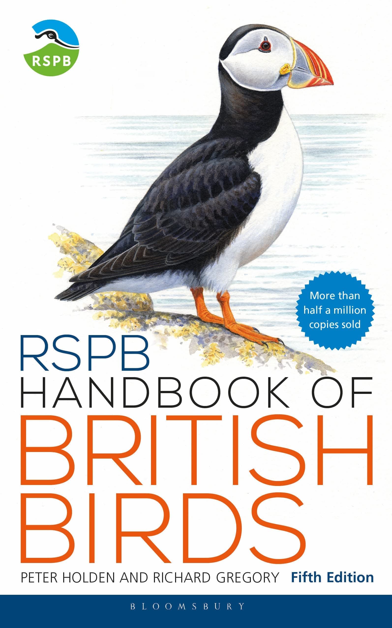 RSPB Pocket Guide to British Birds and RSPB Handbook of British Birds fanned open, revealing inside pages with bird illustrations and identification notes.