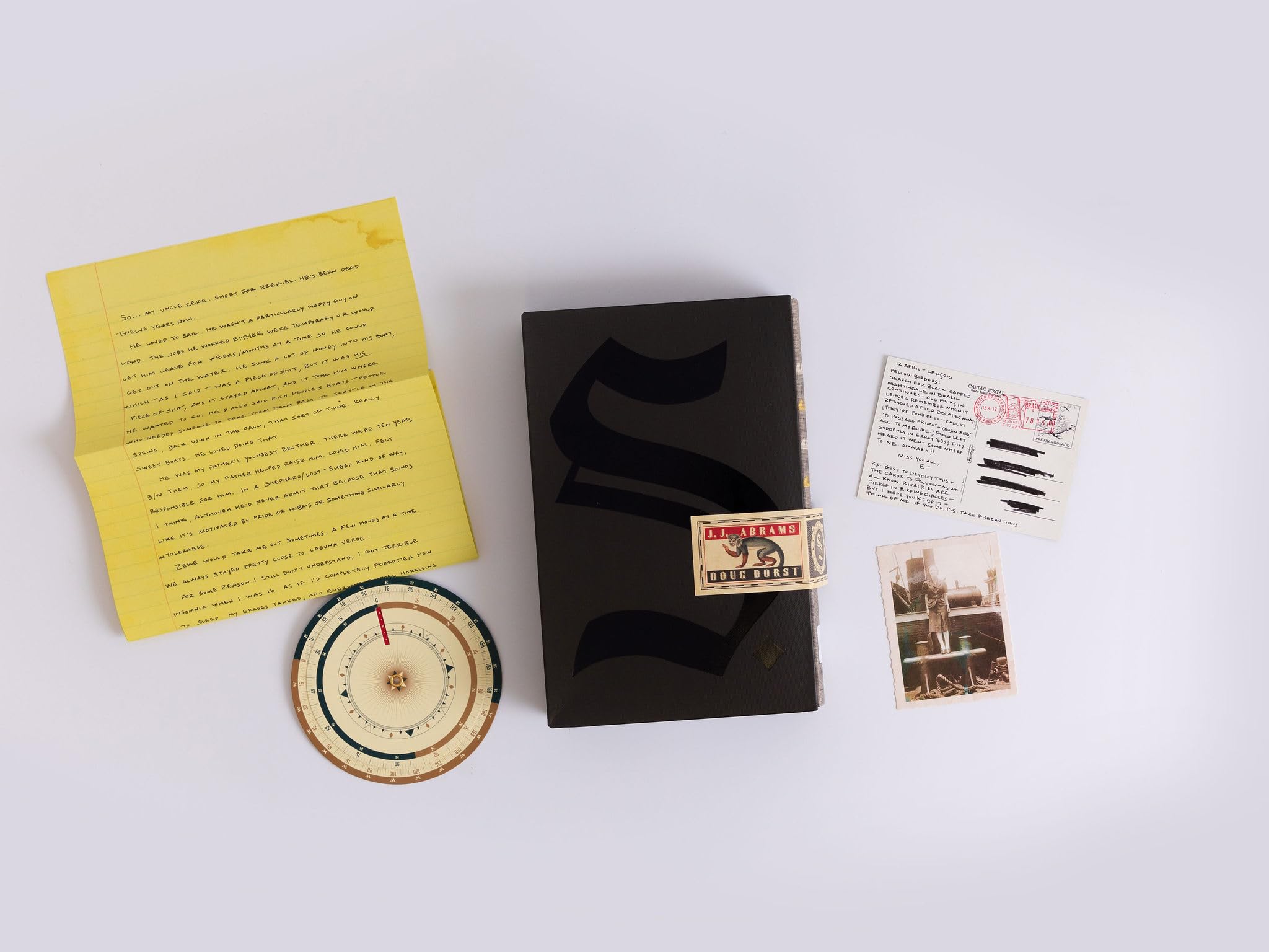 Full view of the S. hardcover book and slipcase with all included ephemera laid out