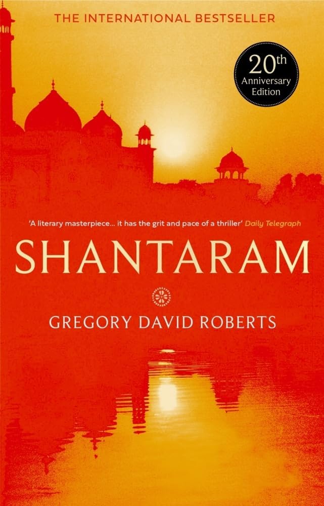 Shantaram and The Mountain Shadow paperback books displayed side by side with spines aligned, showing the full 2 book collection set