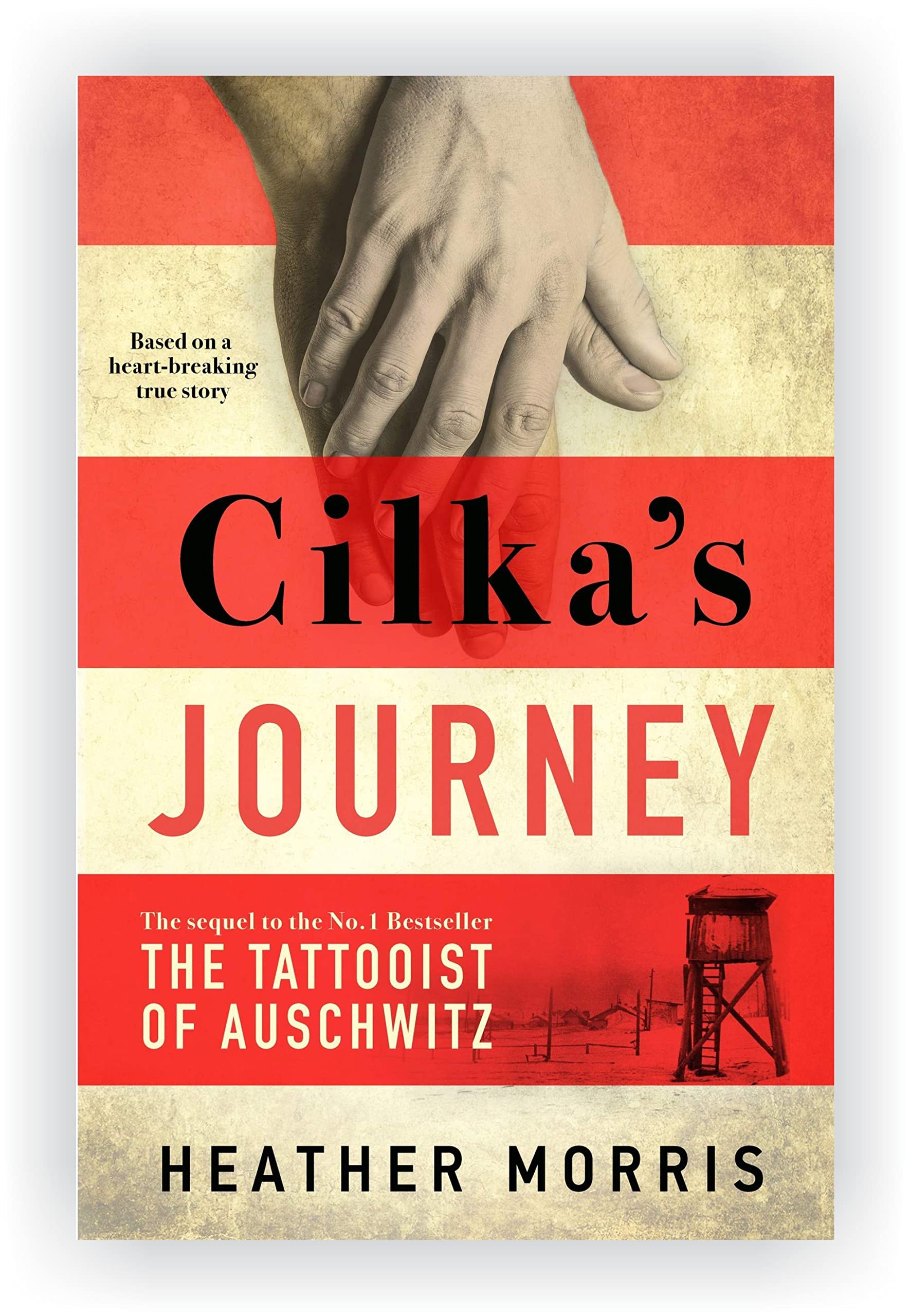 All three paperback books in the Tattooist of Auschwitz trilogy by Heather Morris displayed together on a wooden surface.