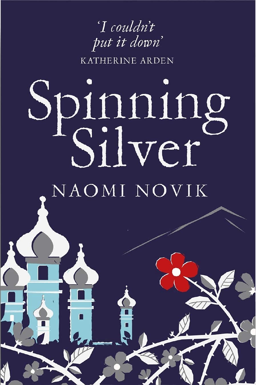 Uprooted and Spinning Silver paperbacks fanned out showing spines and cover art