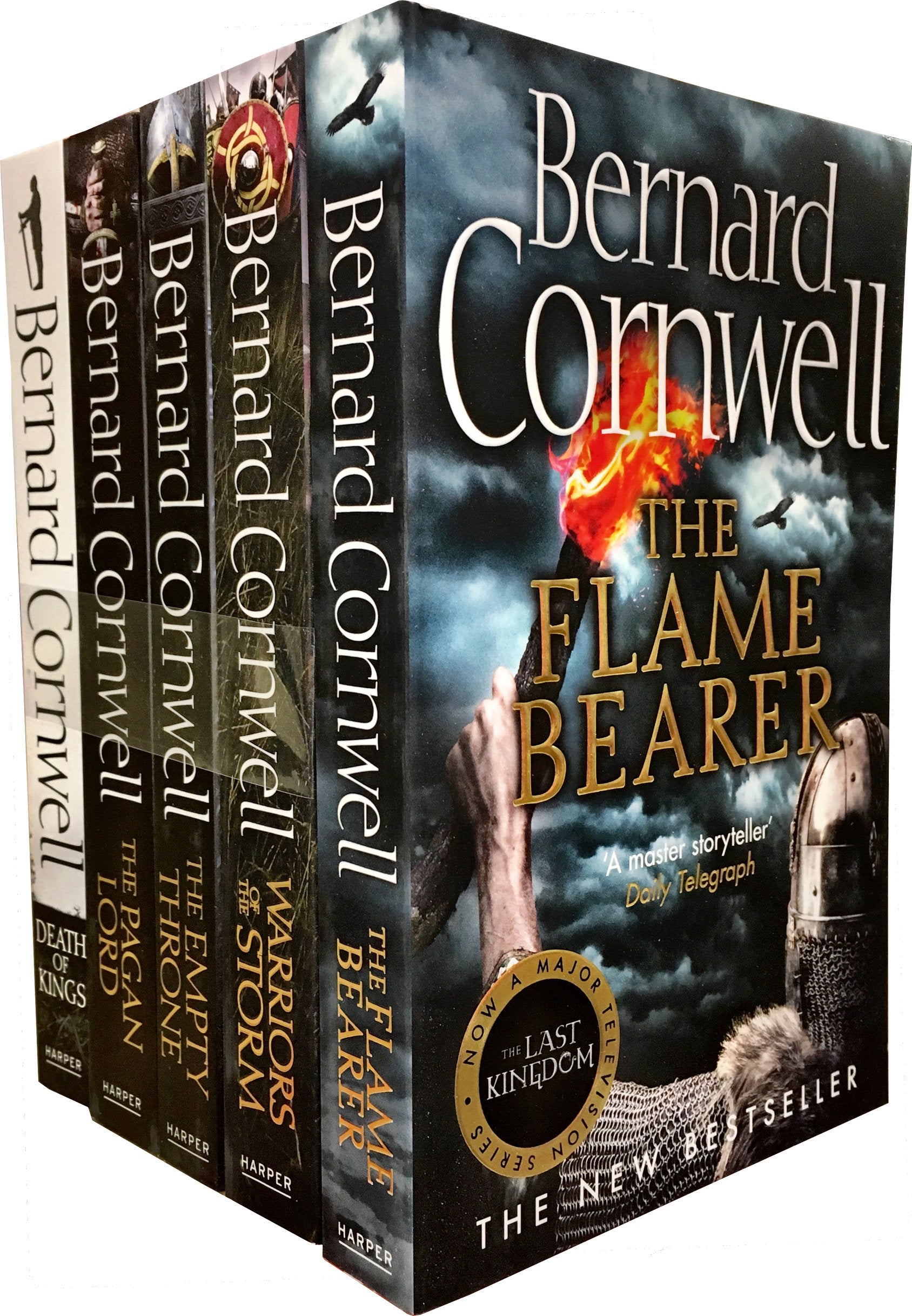 All five paperback books in the Warrior Chronicles (The Last Kingdom Series) by Bernard Cornwell, including Death of Kings, The Pagan Lord, The Empty Throne, Warriors of the Storm, and The Flame Bearer, displayed together.